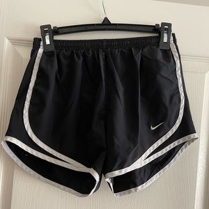 Black Nike shorts with white stripes